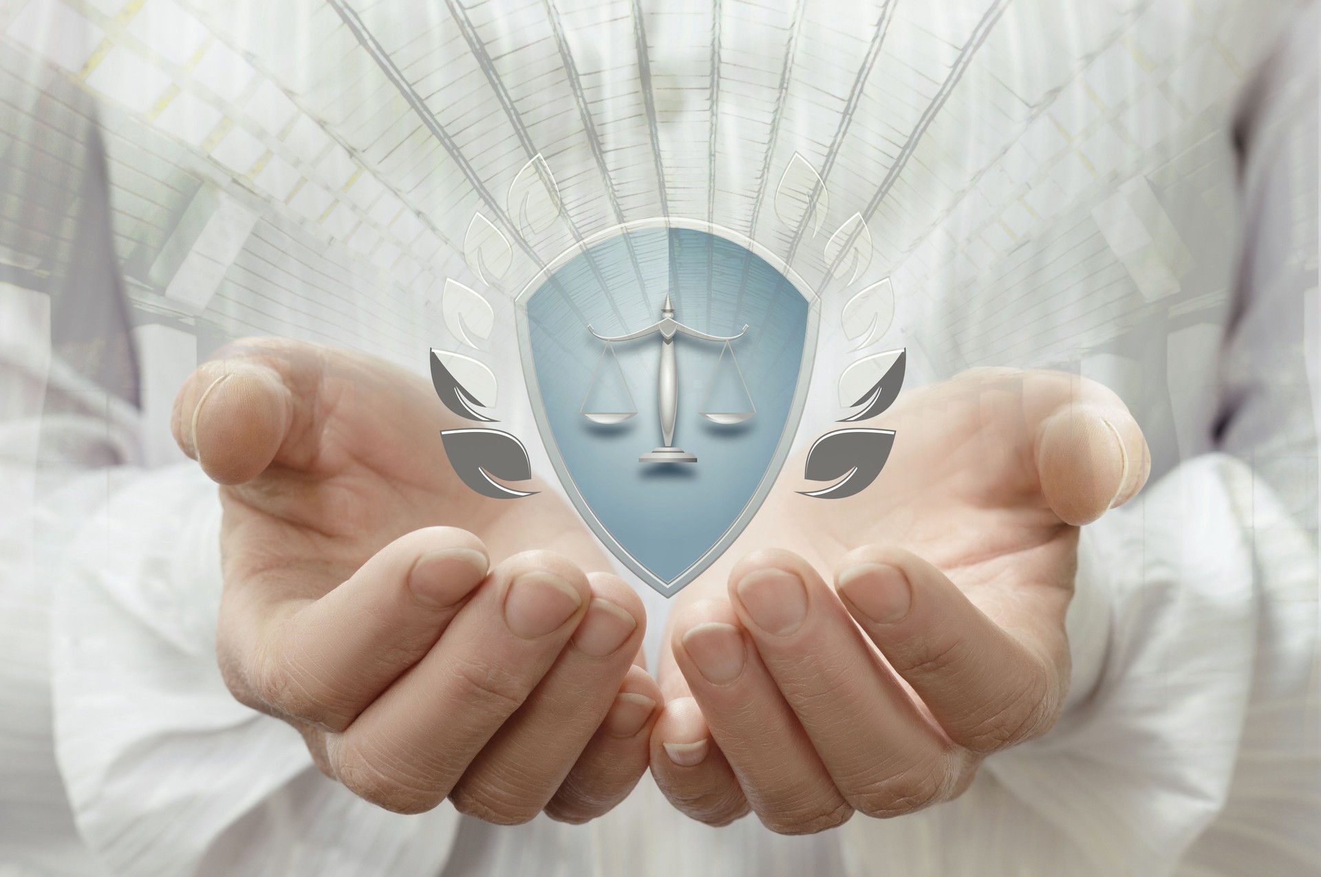Hands holding a shield with scales of justice