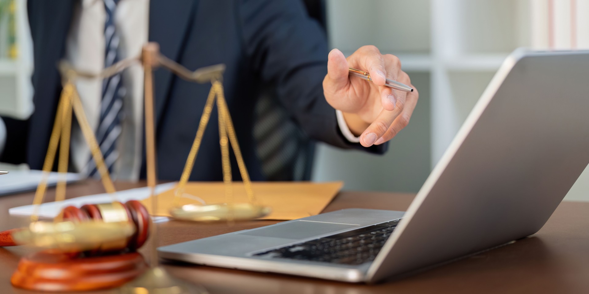 Law and Technology. A lawyer discussing strategies while pointing to a laptop.
